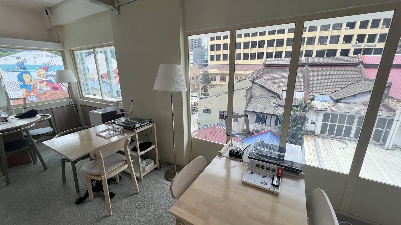 Listening stations by the window with a view of KL